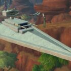 A screenshot of World of Warcraft featuring an Imperial Destroyer ship from Star Wars. The massive, triangular ship was built by a player using housing tools.